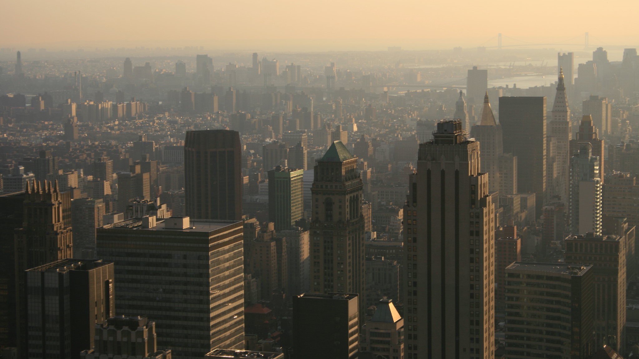 A photo of the New York City skyline with an orange haze in the sky; photo by Urban Feel on Flickr.