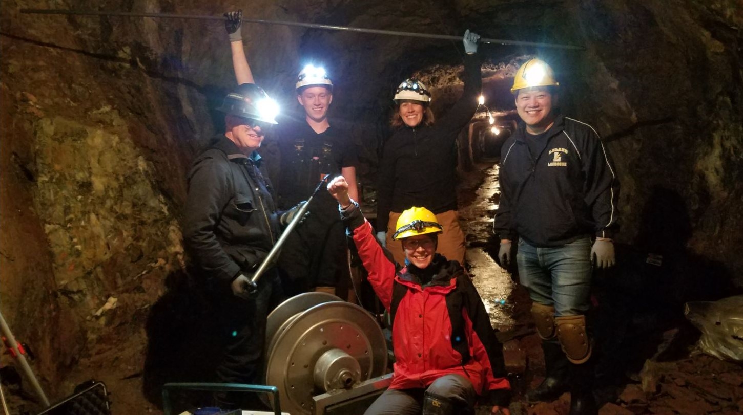 Photo of Dr. Brandy Toner (center in red) and her colleagues in the Soudan Underground Mine by Jim Essig