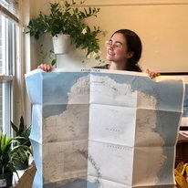 Julia Andreasen holding a map of Antarctica