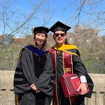 A photo of Luis Allen and his advisor Melissa Wilson in commencement regalia