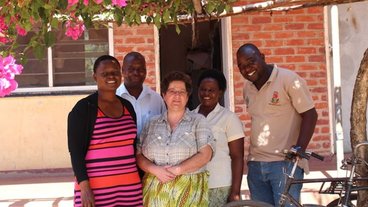 A photo of Dr. Sieglinde Snapp (center) with four Malawi researchers; photo by Vicki Marrone